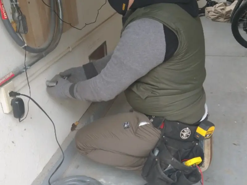 Electrician performing outlet wiring in a Rainbow Lakes Estates garage
